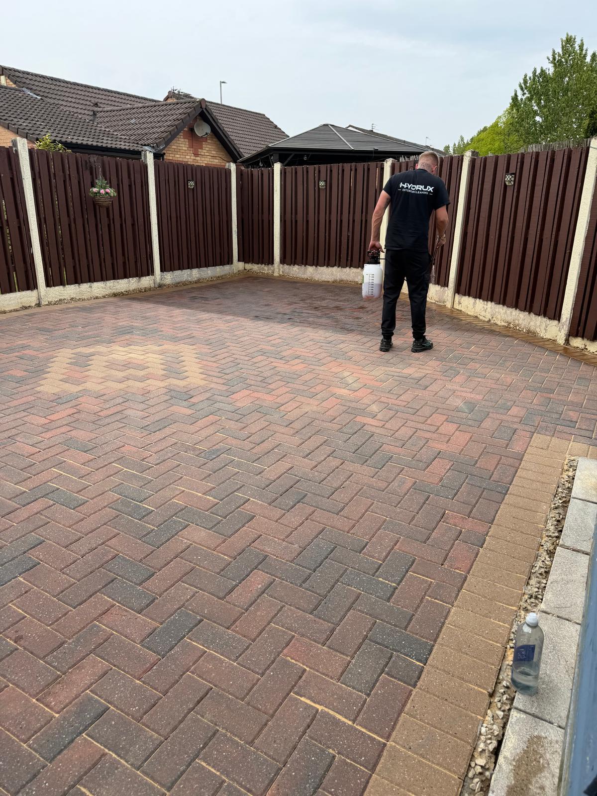 HYDRUX pressure washing a driveway on site